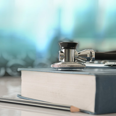 Stethoscope with medical text book on doctor student desk at classroom in the hospital. Stethoscope with medical text book on doctor student desk at classroom in the hospital.